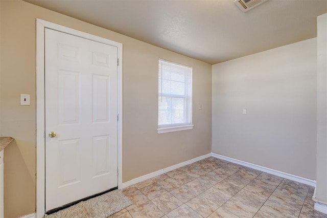 unfurnished room with light tile patterned floors