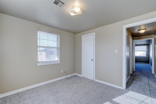 empty room featuring light colored carpet