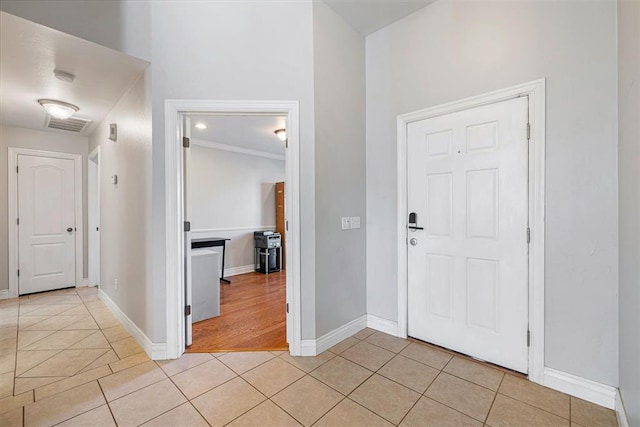 tiled foyer with ornamental molding