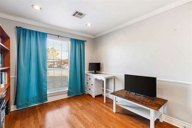 office area with hardwood / wood-style floors and ornamental molding