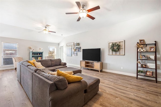 living room with light wood-type flooring, vaulted ceiling, and ceiling fan