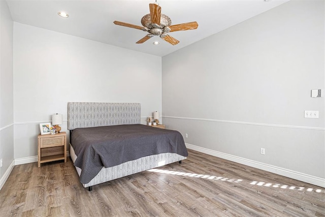 bedroom with ceiling fan and wood-type flooring