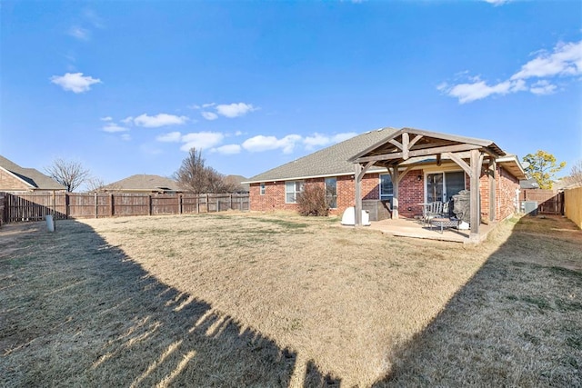 back of house featuring a patio area and a yard