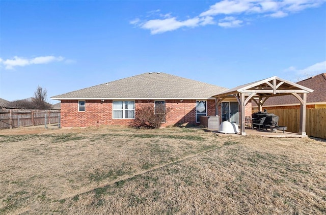 rear view of property with a patio area, a yard, and central AC