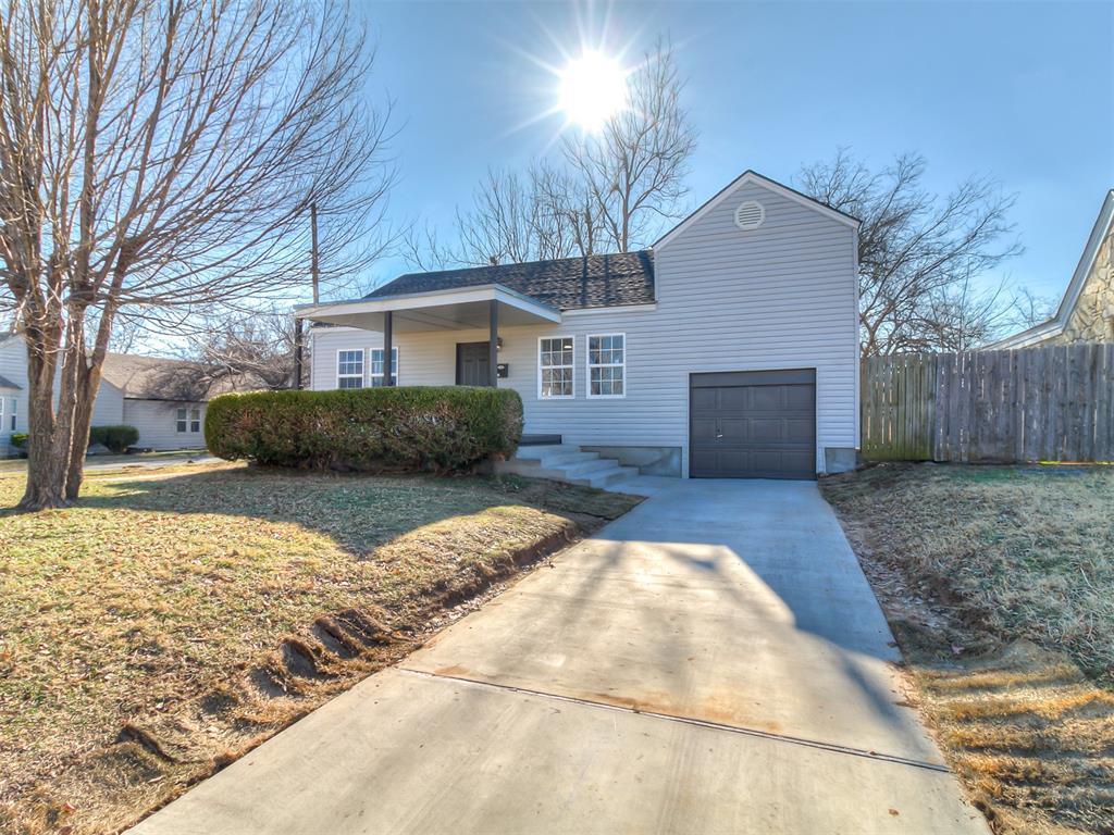 ranch-style home with a front yard and a garage