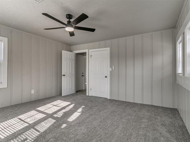 unfurnished bedroom featuring ceiling fan and carpet floors