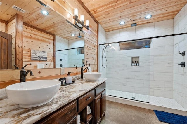 bathroom featuring a tile shower, vanity, and wooden ceiling