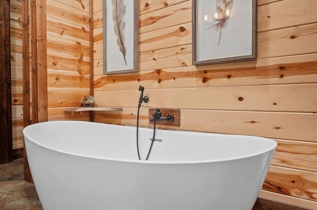 bathroom with a bathing tub and wooden walls