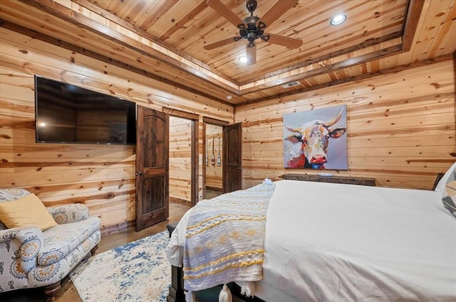 bedroom with a raised ceiling, ceiling fan, wooden walls, and wood ceiling