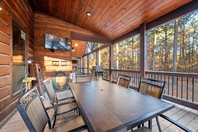 sunroom featuring a healthy amount of sunlight, lofted ceiling, and wood ceiling