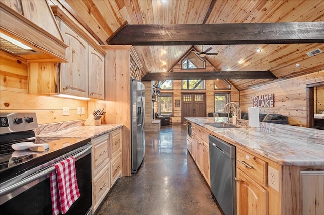 kitchen featuring wooden walls, custom exhaust hood, stainless steel appliances, light brown cabinetry, and a sink