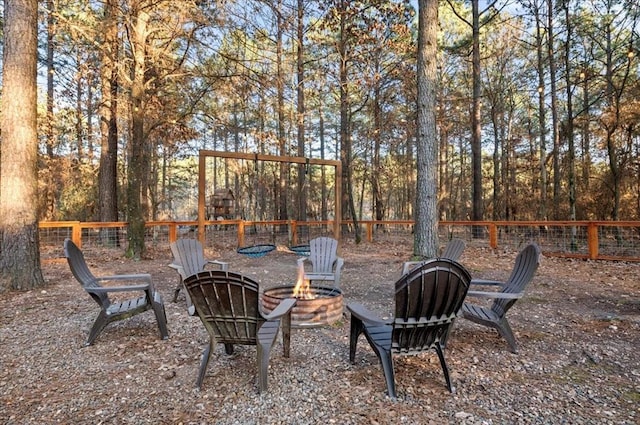 view of yard featuring a fire pit and fence