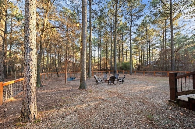 view of yard with fence and a fire pit