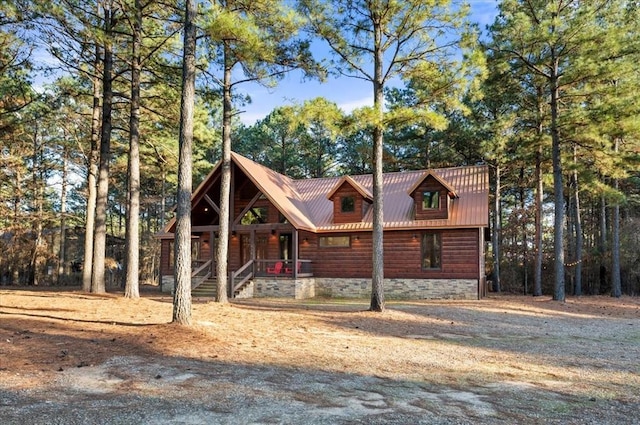 view of front facade featuring covered porch and metal roof