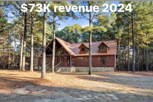 view of front of property featuring covered porch and metal roof