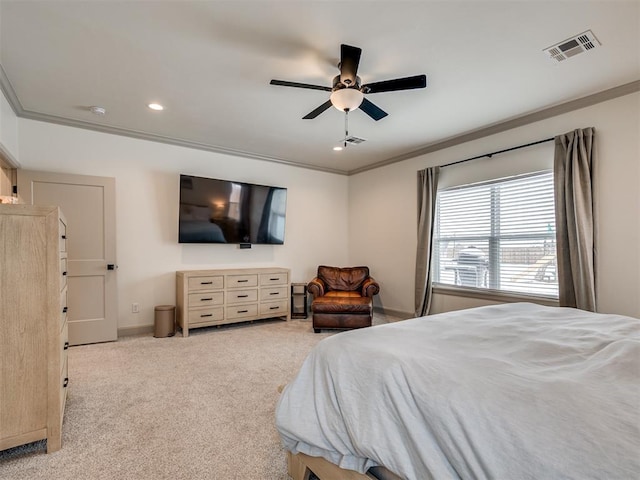 carpeted bedroom with ceiling fan and ornamental molding