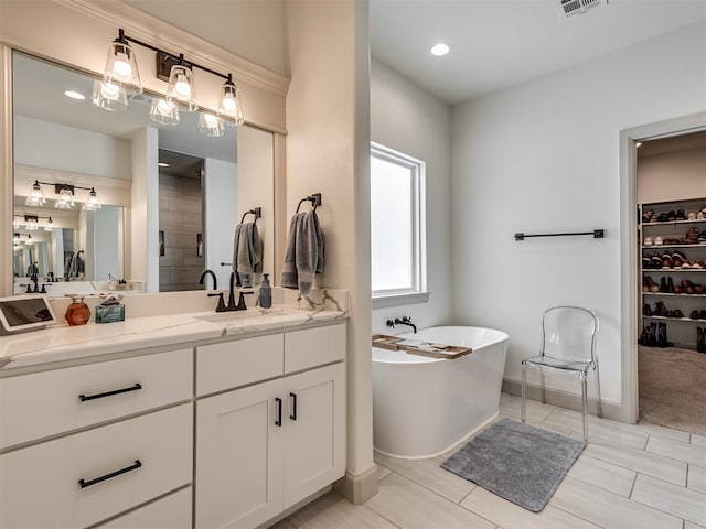 bathroom featuring tile patterned flooring, vanity, and plus walk in shower