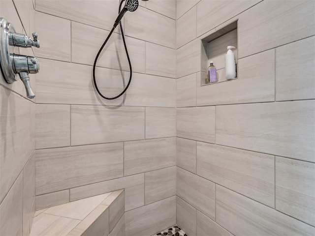 bathroom with tiled shower