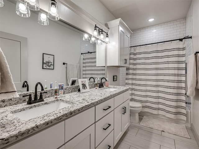 bathroom featuring curtained shower, toilet, vanity, and tile patterned flooring