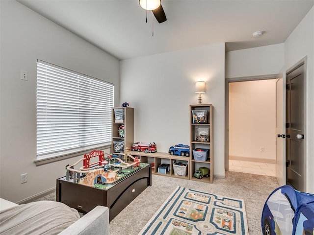 rec room with carpet floors and ceiling fan