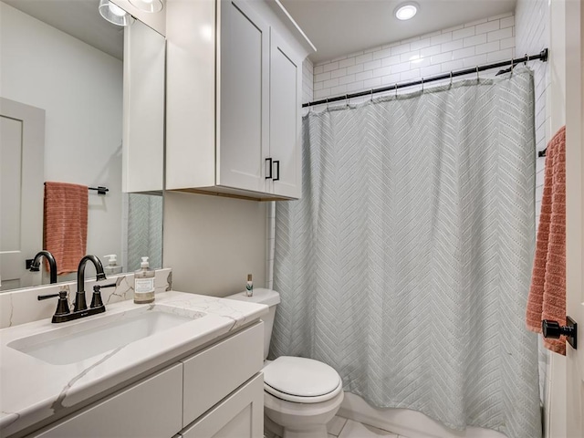 bathroom with vanity, toilet, and curtained shower