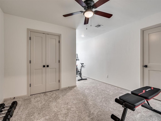 workout area with light colored carpet and ceiling fan