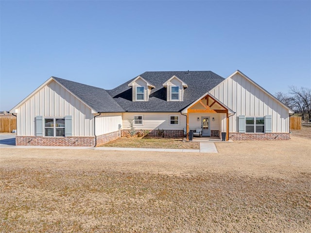 modern inspired farmhouse with a front yard