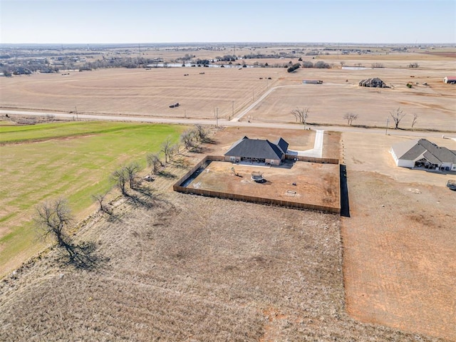 birds eye view of property with a rural view