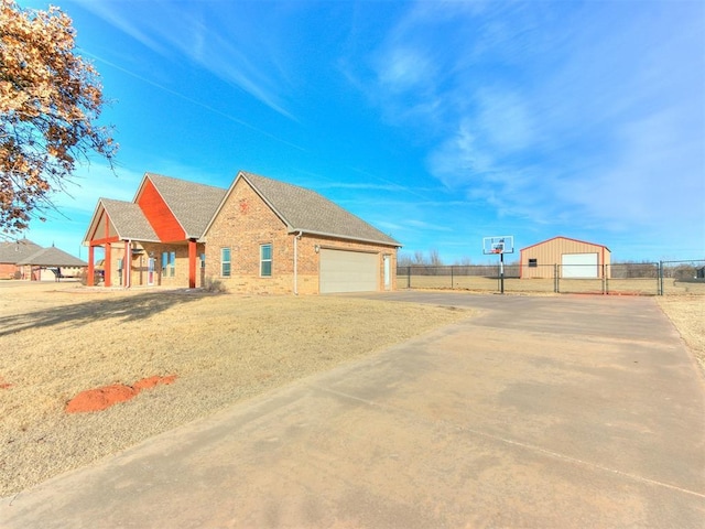 view of front of property featuring covered porch, a garage, and an outdoor structure