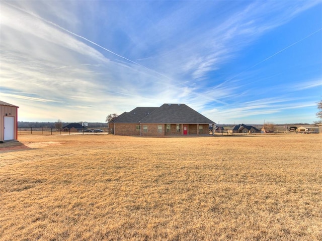 view of yard with a rural view