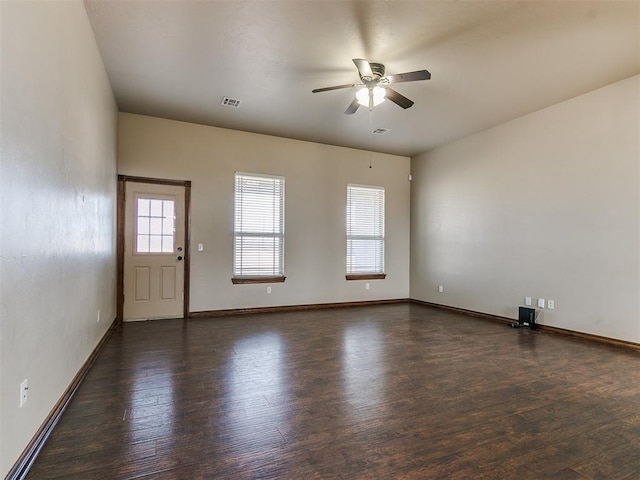 empty room with dark hardwood / wood-style flooring and ceiling fan