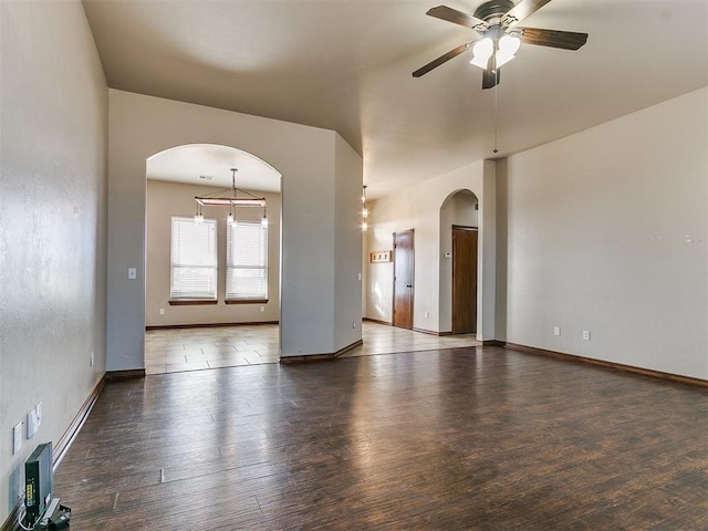 unfurnished room featuring ceiling fan and dark hardwood / wood-style flooring