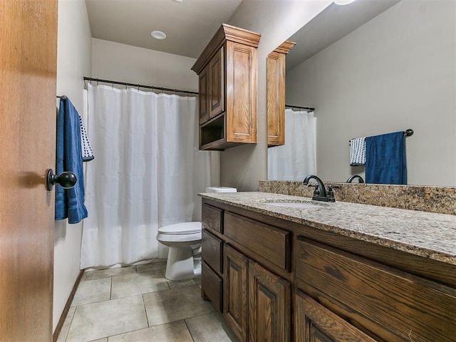 bathroom featuring tile patterned floors, vanity, and toilet