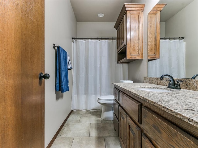 bathroom featuring tile patterned flooring, vanity, and toilet