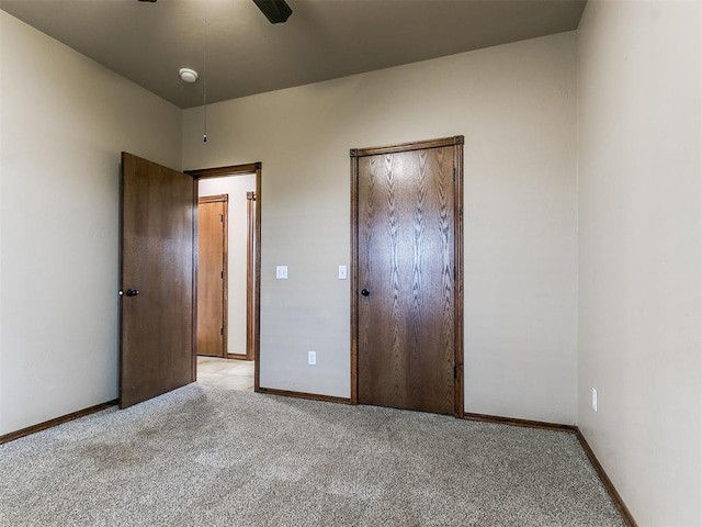 unfurnished bedroom with ceiling fan and light carpet