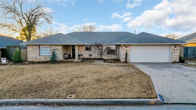 ranch-style house featuring a front yard and a garage