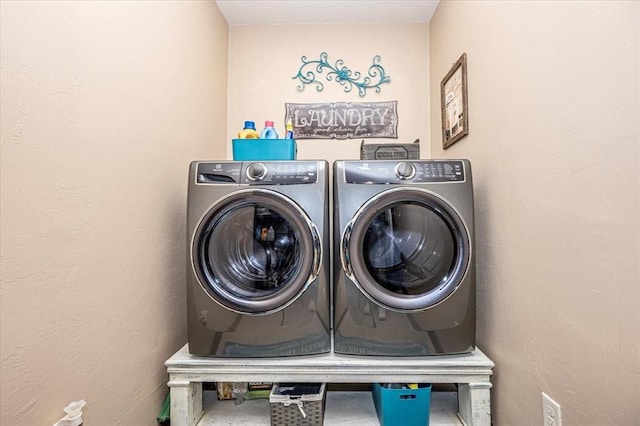 clothes washing area featuring washing machine and dryer