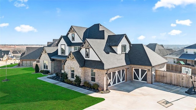 view of front of property featuring a front yard and a garage