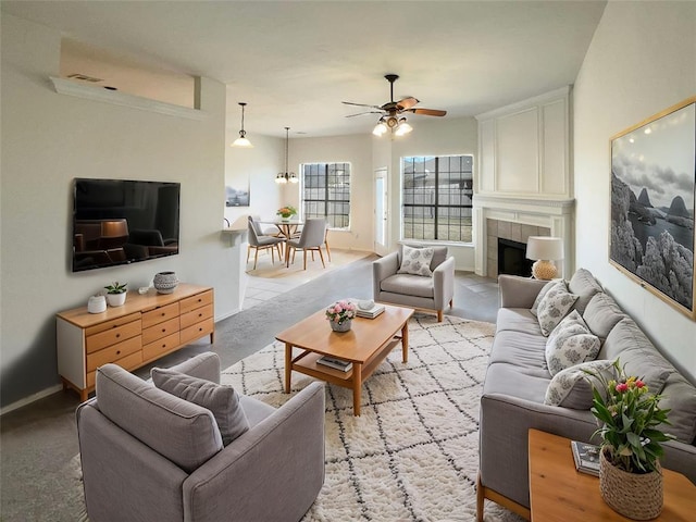 living room with ceiling fan and a tiled fireplace