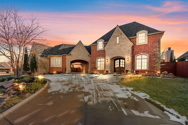 french country home with french doors and a yard