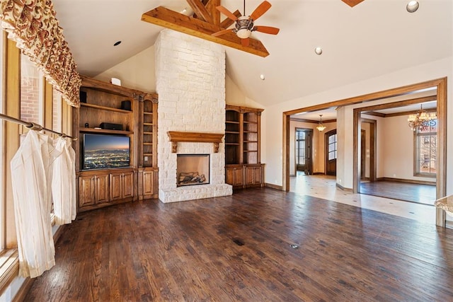 unfurnished living room with dark hardwood / wood-style flooring, beamed ceiling, a fireplace, high vaulted ceiling, and ceiling fan