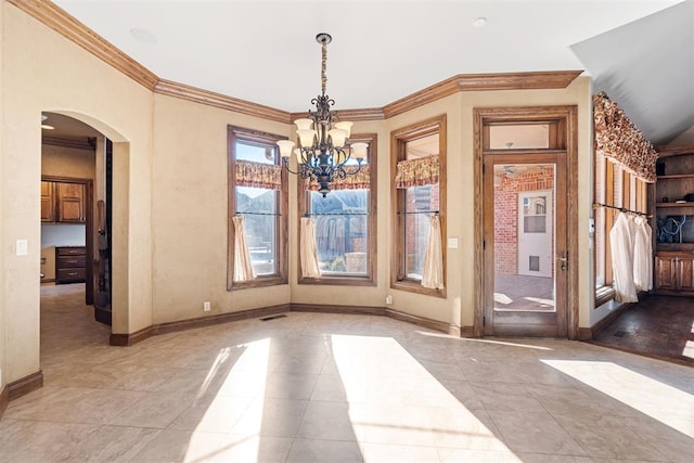 unfurnished dining area with light tile patterned floors, crown molding, and an inviting chandelier