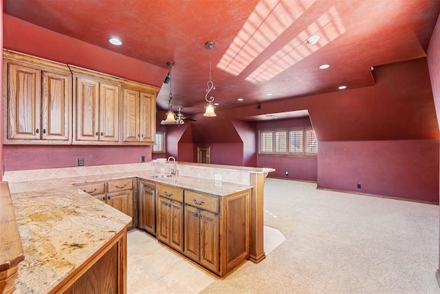 kitchen with vaulted ceiling, pendant lighting, kitchen peninsula, sink, and light carpet