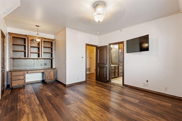 unfurnished living room featuring ceiling fan and dark hardwood / wood-style floors