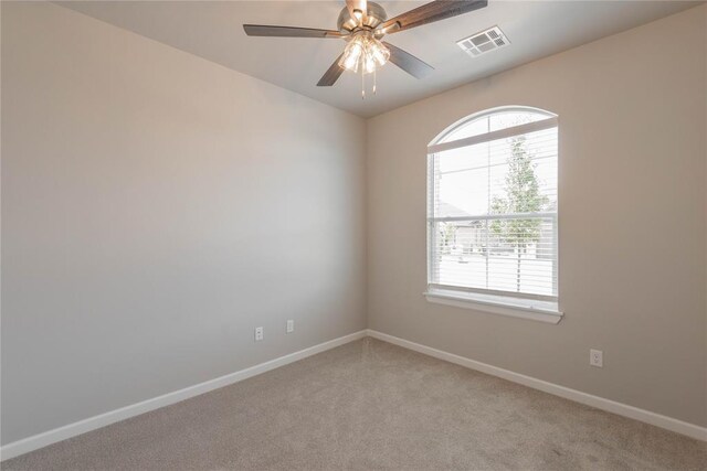 1300 Colonial Ave, Tuttle, OK 73089 - spare room featuring ceiling fan, plenty of natural light, and light carpet