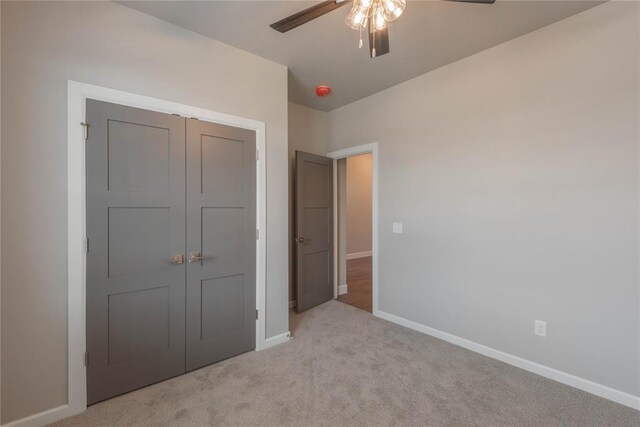 1300 Colonial Ave, Tuttle, OK 73089 - unfurnished bedroom featuring light colored carpet, ceiling fan, and a closet
