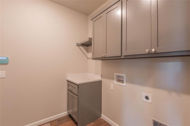 1300 Colonial Ave, Tuttle, OK 73089 - washroom with cabinets, electric dryer hookup, dark wood-type flooring, and washer hookup