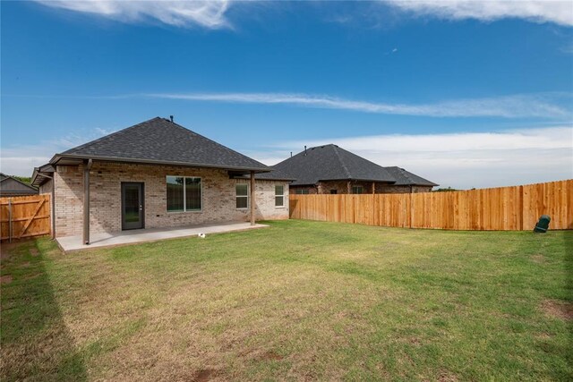 1300 Colonial Ave, Tuttle, OK 73089 - back of property featuring a yard and a patio area