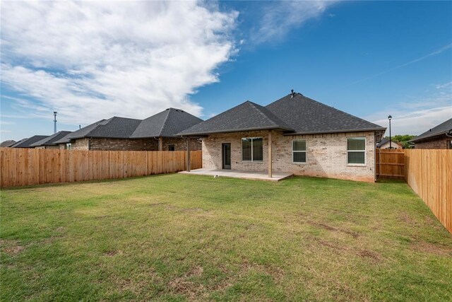 1300 Colonial Ave, Tuttle, OK 73089 - back of house with a yard and a patio area