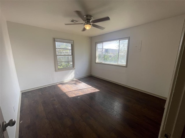 spare room featuring ceiling fan and dark hardwood / wood-style flooring